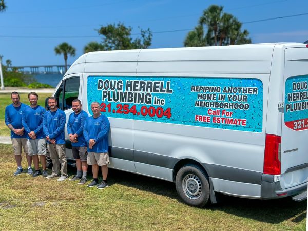 doug herrell and team in front of company vehicle